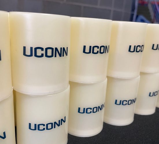 A stack of white UConn votive candles that are distributed to students at Convocation