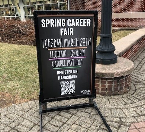 Outdoor chalkboard-style sign announcing a Spring Career Fair