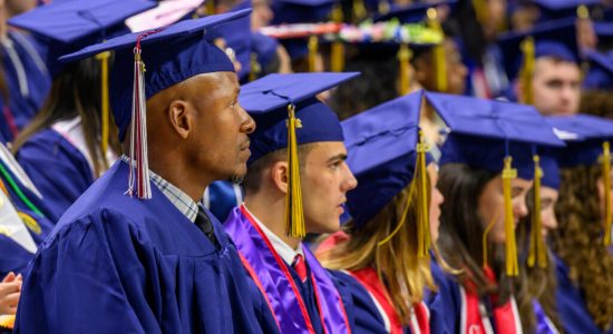 Former UConn basketball star Ray Allen participating in a commencement ceremony along with other graduates in regalia