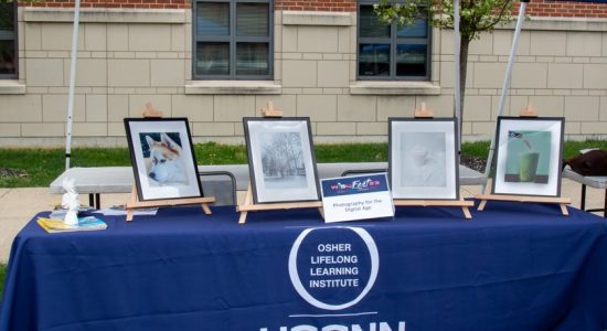 Outdoor booth at the 2023 WISH Fest displaying framed photos