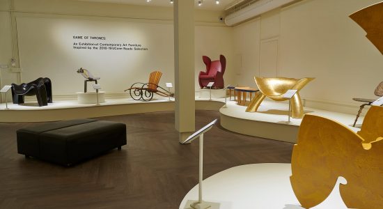 Display of stylized chairs in a variety of materials and colors in the Benton Museum of Art