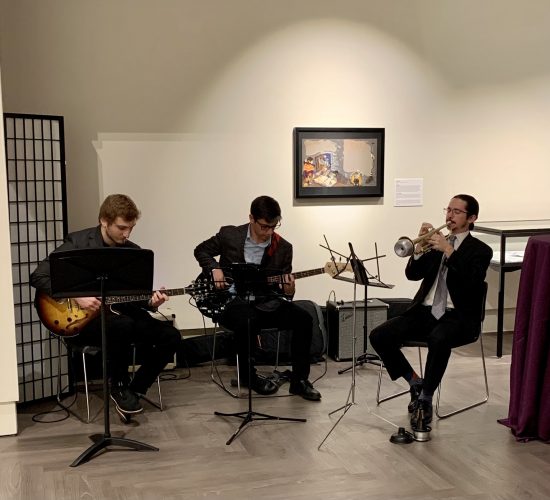 Three individuals playing instruments in the Benton Museum at the 2023 UConn Honors event