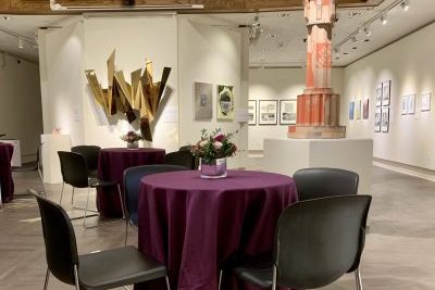 Tables and chairs set up for an event in a museum space