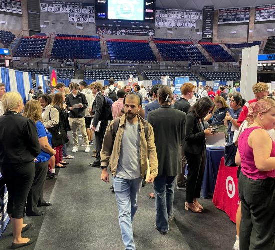 Career fair in Gampel Pavilion with students visiting various company booths