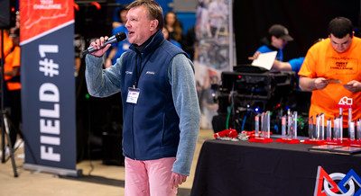 Announcer speaking into a microphone at the 2024 FTC Robotics Tournament at UConn.