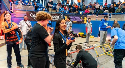 Robotics student team members working on their robots in preparation for competition at the 2024 FTC Robotics Tournaments at UConn.