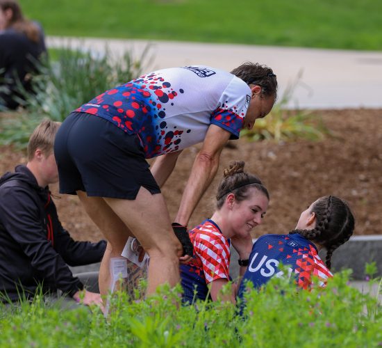 group of people in running attire sitting and talking