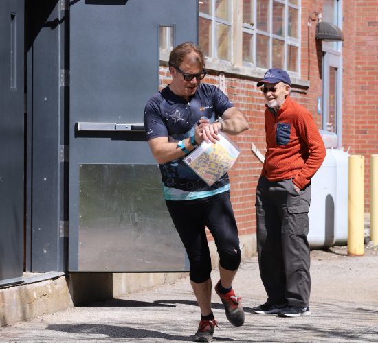 Orienteering participant running past a checkpoint